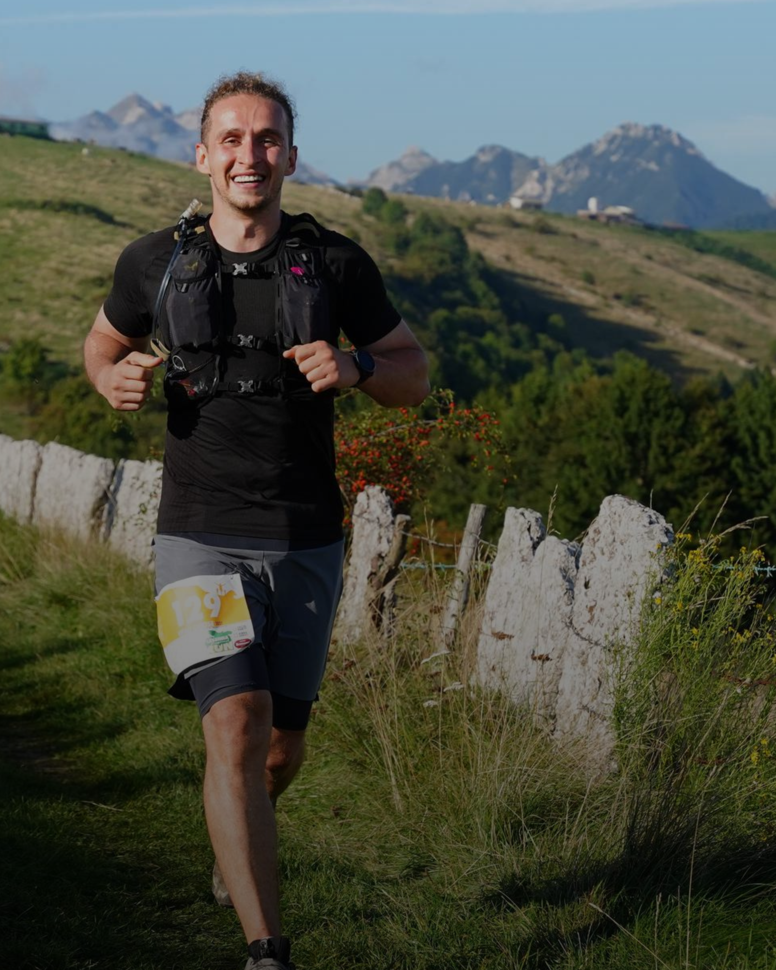 Mann läuft Ultramarathon auf Bergtrail in den Dolomiten mit felsigen Gipfeln im Hintergrund