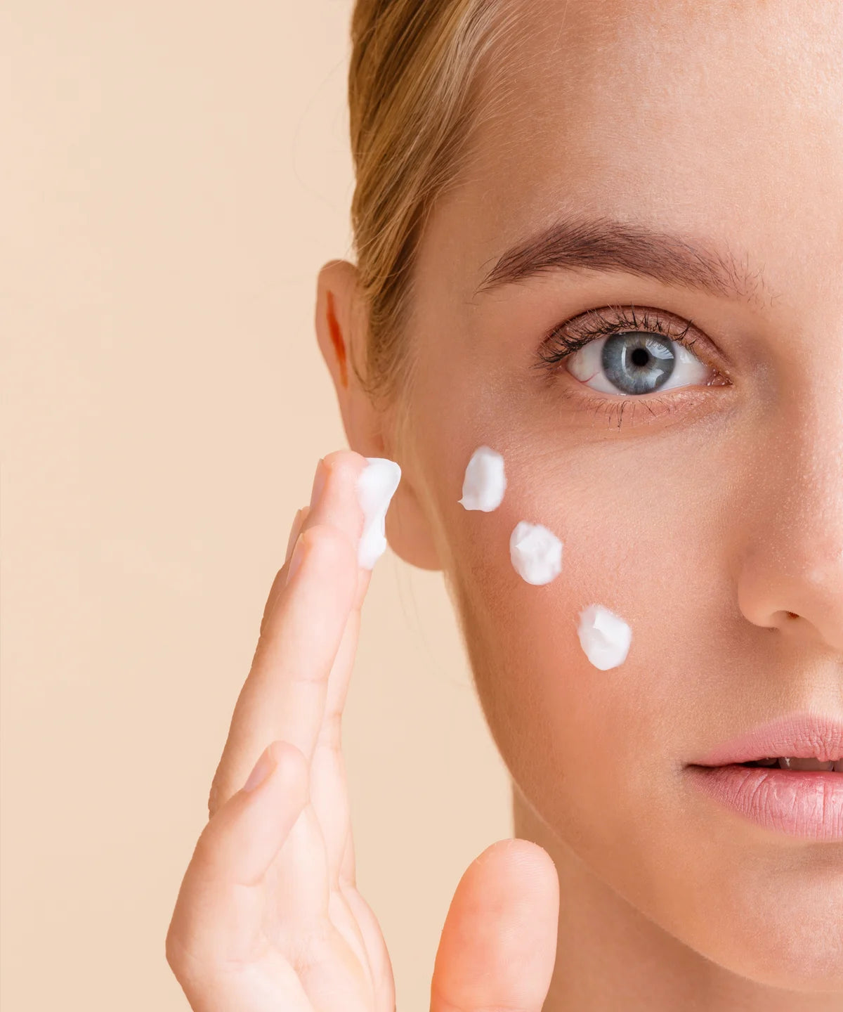 Nahaufnahme einer Person, die „Clean Skin“ Gesichtsreiniger punktuell auf die Wange aufträgt – sanfte Hautpflege-Anwendung im Beauty-Kontext.