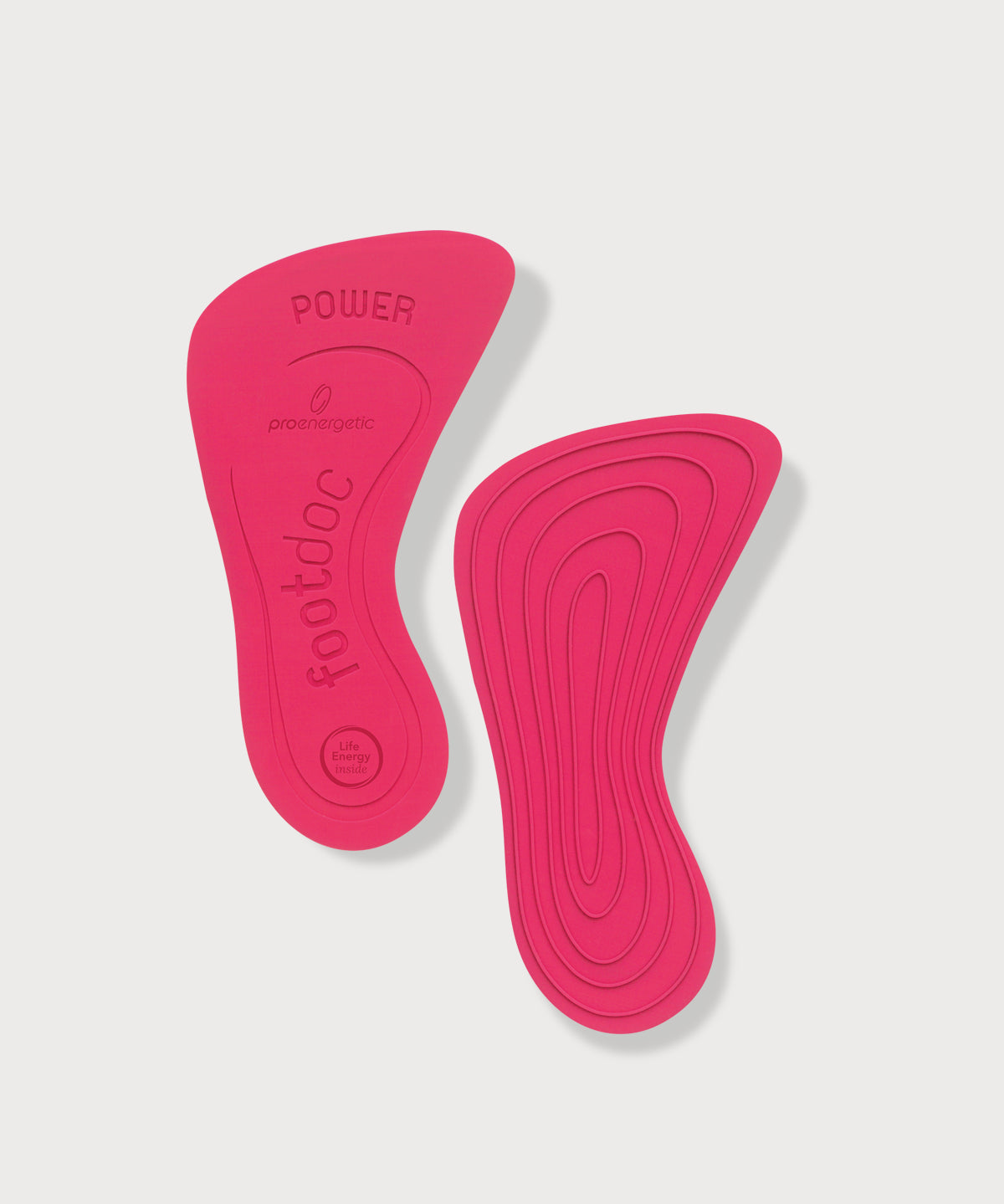 Zwei pinke Footdoc Power Einlegesohlen mit geprägter Struktur auf hellem Hintergrund