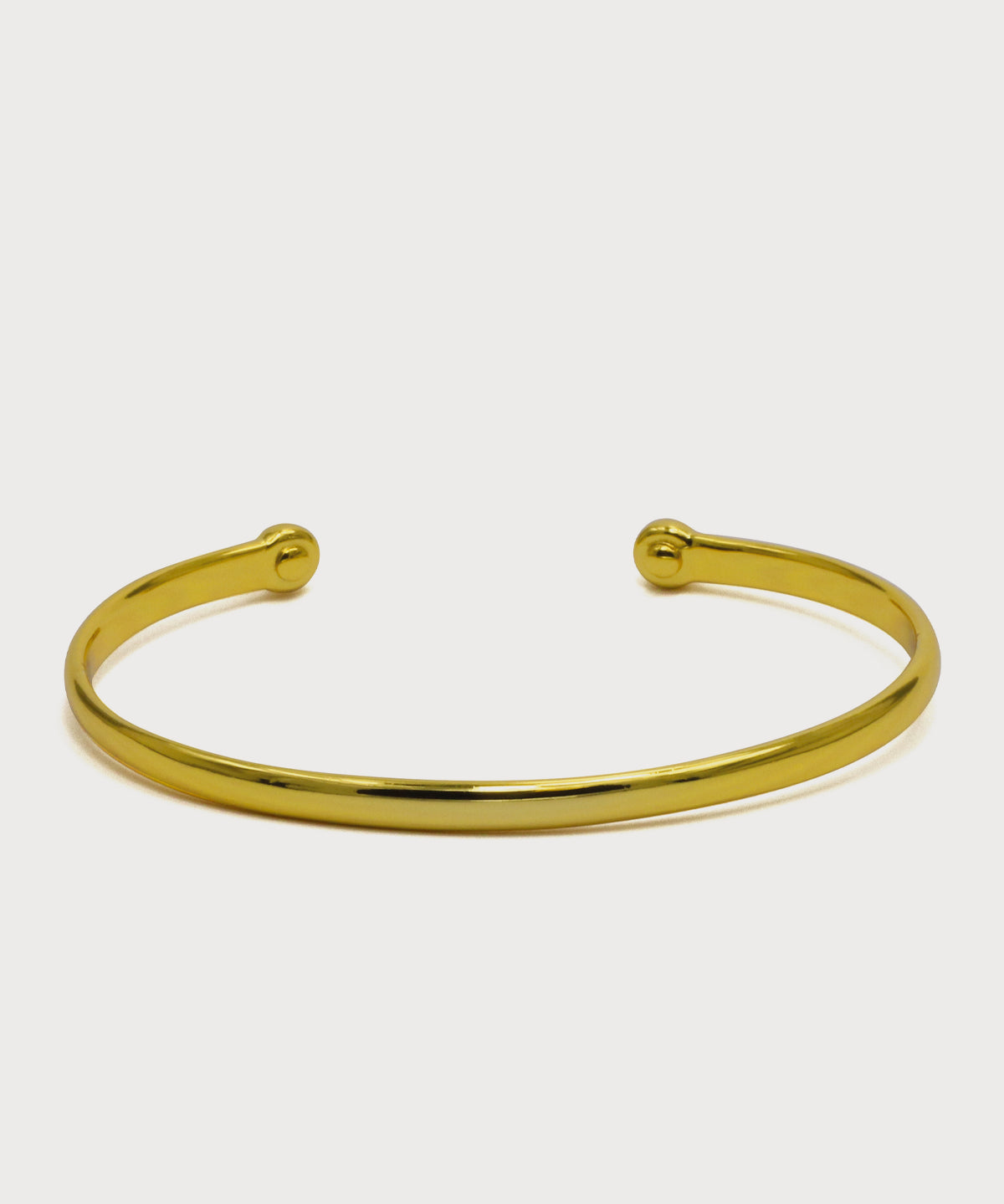 Goldfarbener Vitality Bangle Armreif mit offenem Design auf hellem Hintergrund